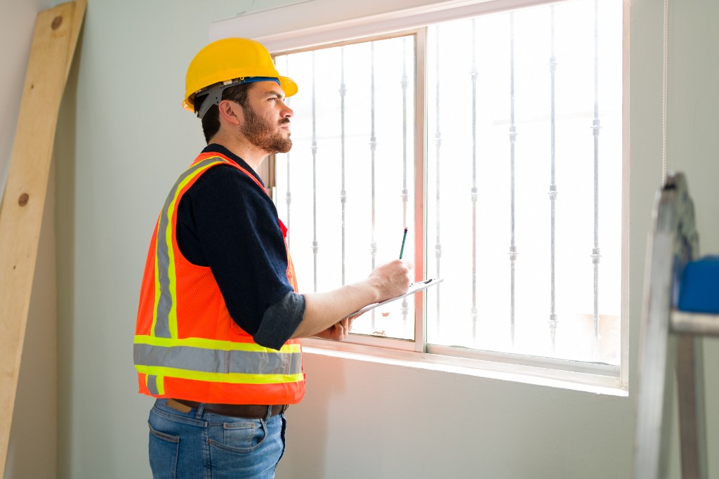 Specialist inspecting a window before replacement